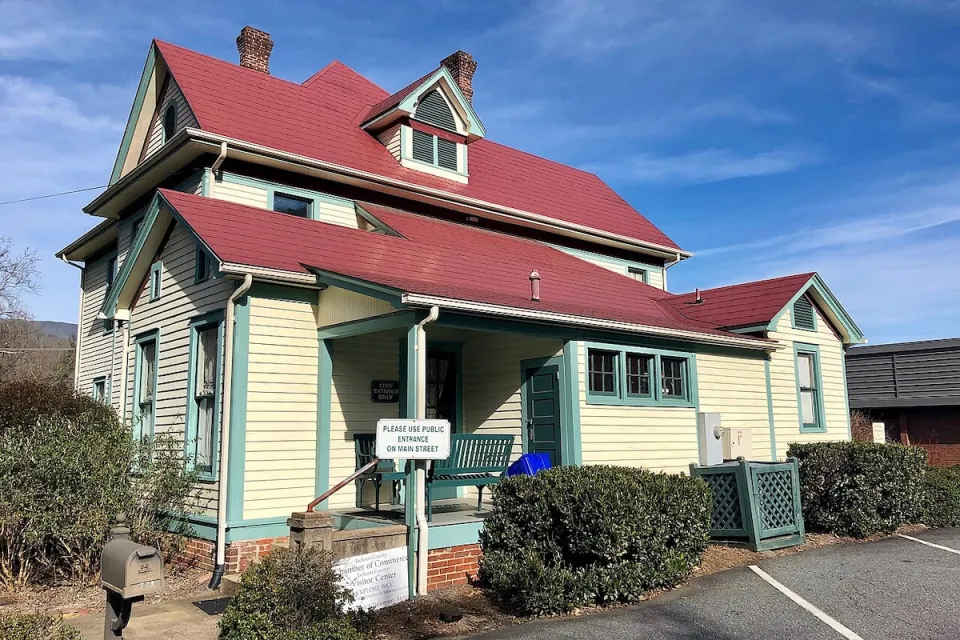 Pale yellow Sears kit house with red tile roof in Sylva, North Carolina.